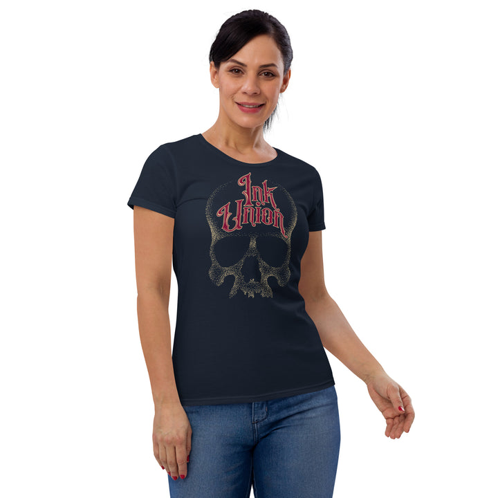 An attractive woman wears a navy blue t-shirt with a dot work gold skull on the chest. Arching across the forehead of the skull are the words Ink Union in fancy red and gold lettering.