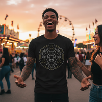 Insomnia Skull Mandala Tee — Tattooed Black male model wearing black Ink Union Insomnia skull mandala dark art unisex graphic tee laughing with friends at vibrant outdoor carnival at golden hour sunset with colorful rides and warm glowing sky in background — alternative streetwear, tattoo artist t-shirt, unisex graphic tee, edgy cool fashion