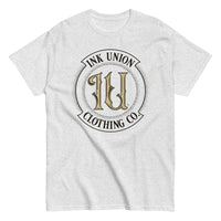 An ash grey t-shirt with the Ink Union Clothing Co Badge logo in black and gold centered on the front of the shirt.
