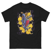 A black t-shirt with a bed of yellow ginkgo leaves and a blue tattoo machine popping out of the leaves. There is a purple mist in the background.