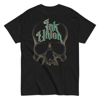 A black t-shirt  adorned with a gold dot work human skull and the words Ink Union in fancy gold and green lettering across the forehead of the skull.