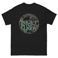 A black t-shirt adorned with the Ink Union Tattoo Co. green and gold with a Silver tattoo machine logo.