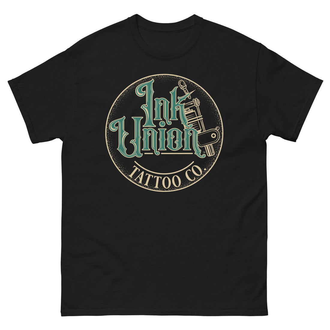 A black t-shirt with a gold circle containing fancy lettering in green and gold that says Ink Union and a gold tattoo machine peeking out from behind on the right side.  There is a dot work gradient inside the circle, and the words Tattoo Co. in gold are at the bottom of the design.
