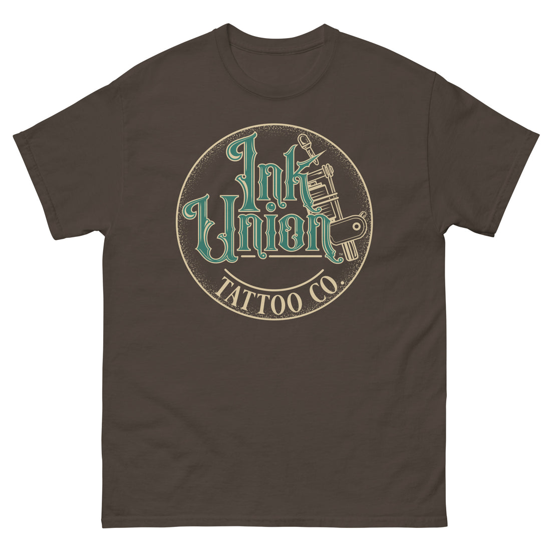 A dark brown t-shirt with a gold circle containing fancy lettering in green and gold that says Ink Union and a gold tattoo machine peeking out from behind on the right side.  There is a dot work gradient inside the circle, and the words Tattoo Co. in gold are at the bottom of the design.