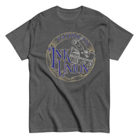 A dark grey t-shirt adorned with the Ink Union Tattoo Co. blue and gold with a silver tattoo machine logo.
