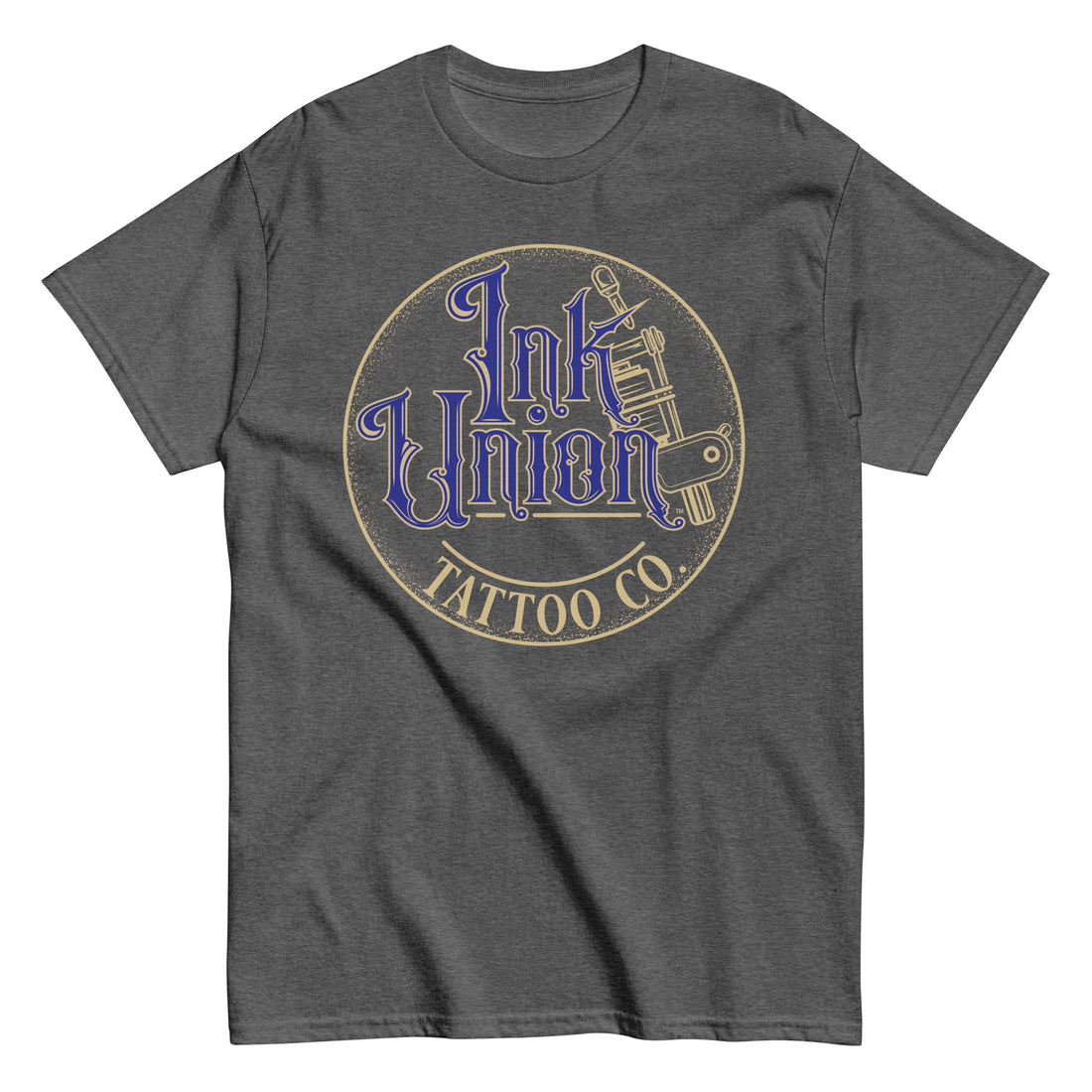 A dark grey t-shirt with a gold circle containing fancy lettering in blue and gold that says Ink Union and a gold tattoo machine peeking out from behind on the right side. There is a dot work gradient inside the circle, and the words Tattoo Co. in gold are at the bottom of the design.