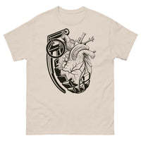 A light brown t-shirt with a black crescent moon and stars with an ornate moth in front of the bottom of the moon facing upward.
