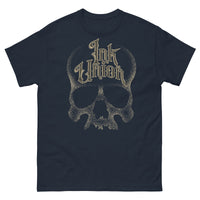 A navy t-shirt with a gold dot work human skull and the words Ink Union in fancy gold and black lettering across the forehead of the skull.