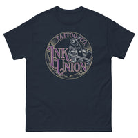 A navy-blue t-shirt adorned with the Ink Union Tattoo Co. purple and gold with a silver tattoo machine logo.