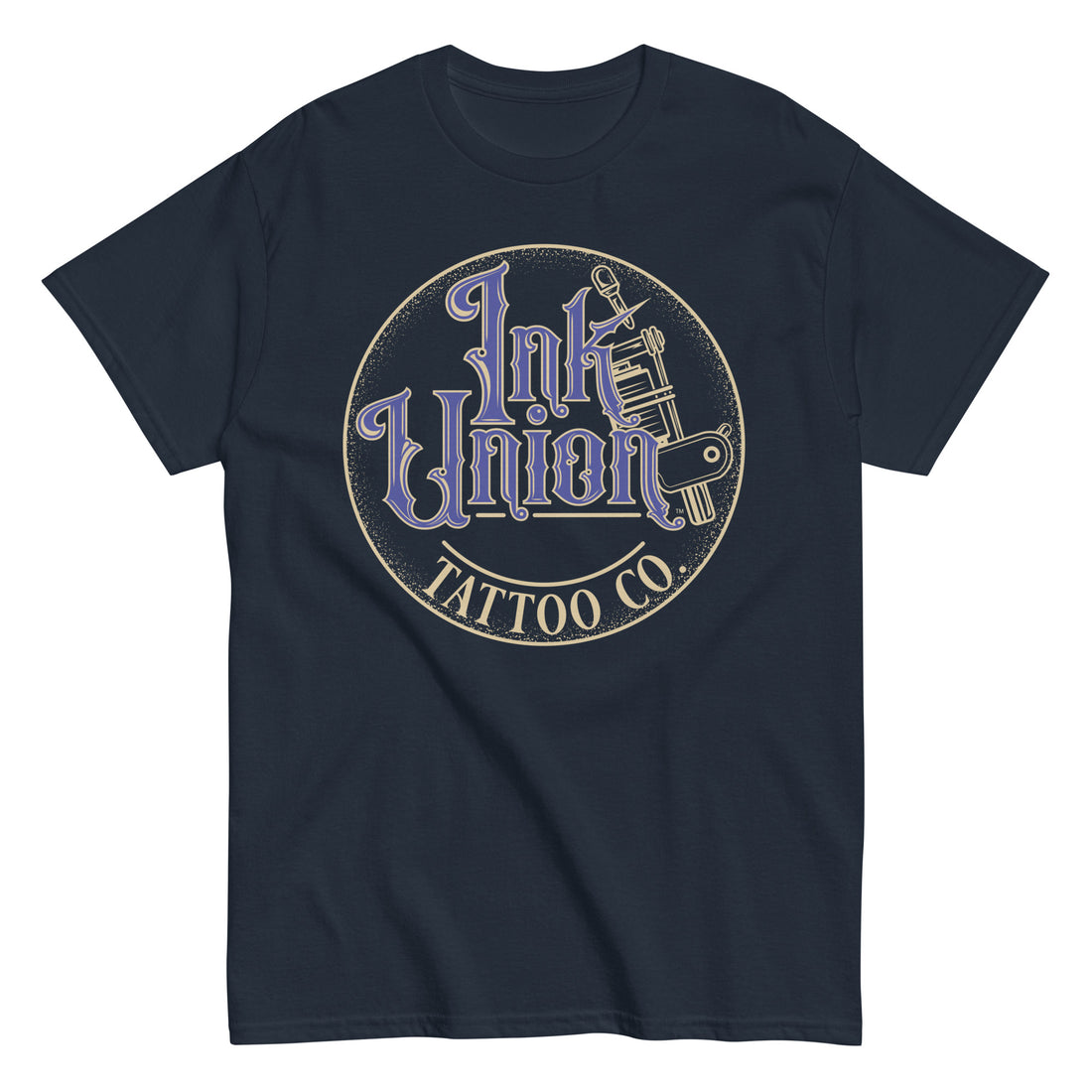 A navy blue t-shirt with a gold circle containing fancy lettering in blue and gold that says Ink Union and a gold tattoo machine peeking out from behind on the right side.  There is a dot work gradient inside the circle, and the words Tattoo Co. in gold are at the bottom of the design.