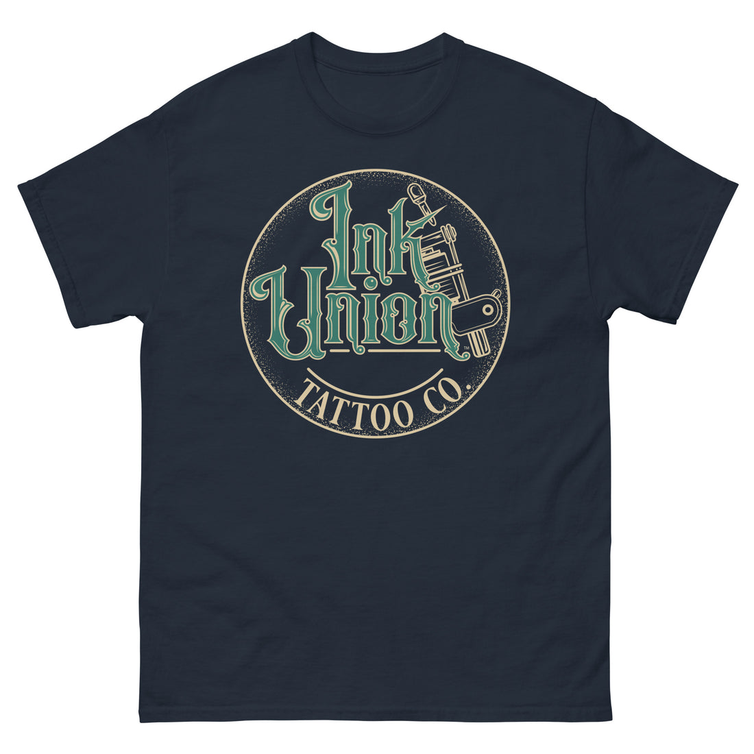 A navy blue t-shirt with a gold circle containing fancy lettering in green and gold that says Ink Union and a gold tattoo machine peeking out from behind on the right side.  There is a dot work gradient inside the circle, and the words Tattoo Co. in gold are at the bottom of the design.