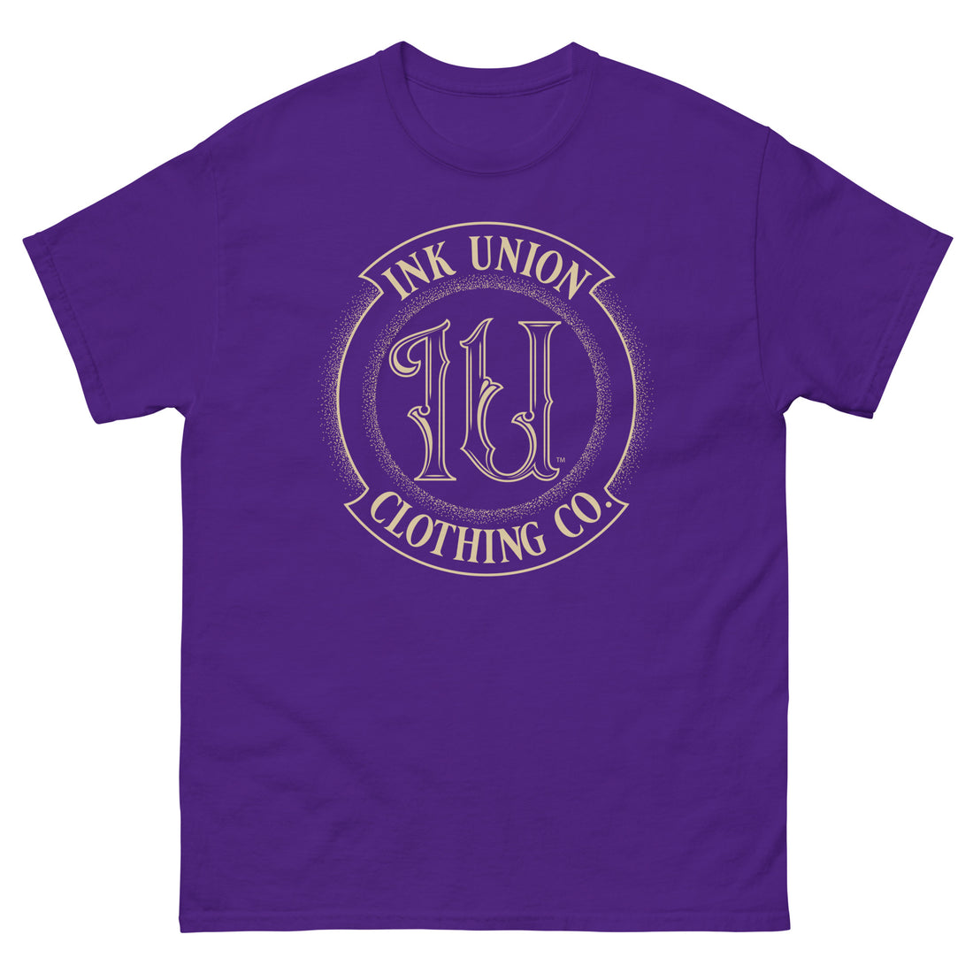 A purple t-shirt adorned with the Ink Union Clothing Co gold badge logo containing fancy lettering and dot work gradients.