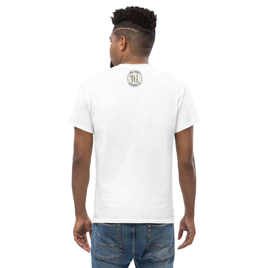 The back view is of an attractive man wearing a white t-shirt with a small gold and black Ink Union badge Logo centered just under the neckline.