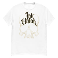 A white t-shirt adorned with a gold dot work human skull and the words Ink Union in fancy gold and black lettering across the forehead of the skull.
