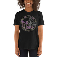 An attractive woman wearing a black t-shirt adorned with the Ink Union Tattoo Co. purple and gold with a silver tattoo machine logo.