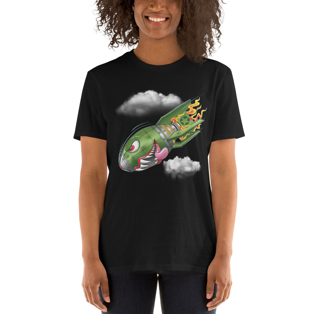 An attractive woman wears a black t-shirt with a military green neo-traditional bomb tattoo design. The bomb is falling with a look of determination in its eyes, an evil toothy grin, and its tongue hanging out of its mouth. Flames are coming from the back of the bomb, and some clouds are in the background.