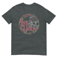 A dark grey t-shirt adorned with the Ink Union Tattoo Co. red and gold with a silver tattoo machine logo.