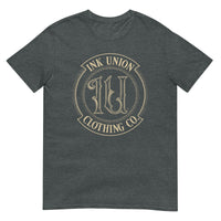 A dark grey t-shirt adorned with the Ink Union Clothing Co gold badge logo containing fancy lettering and dot work gradients.
