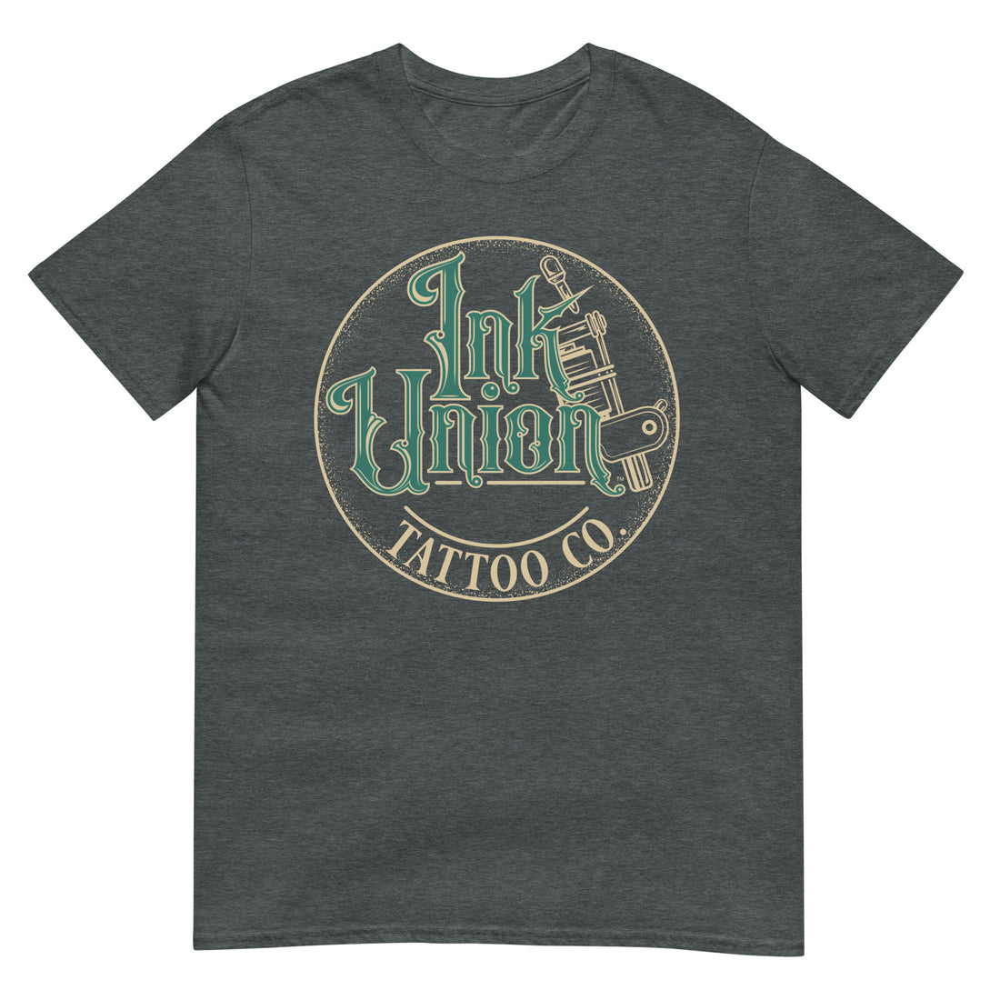 A dark grey t-shirt with a gold circle containing fancy lettering in green and gold that says Ink Union and a gold tattoo machine peeking out from behind on the right side. There is a dot work gradient inside the circle, and the words Tattoo Co. in gold are at the bottom of the design.