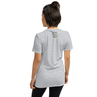 The rear view of an attractive woman wearing a light grey t-shirt with a small gold and black Ink Union badge logo centered just under the neckline.