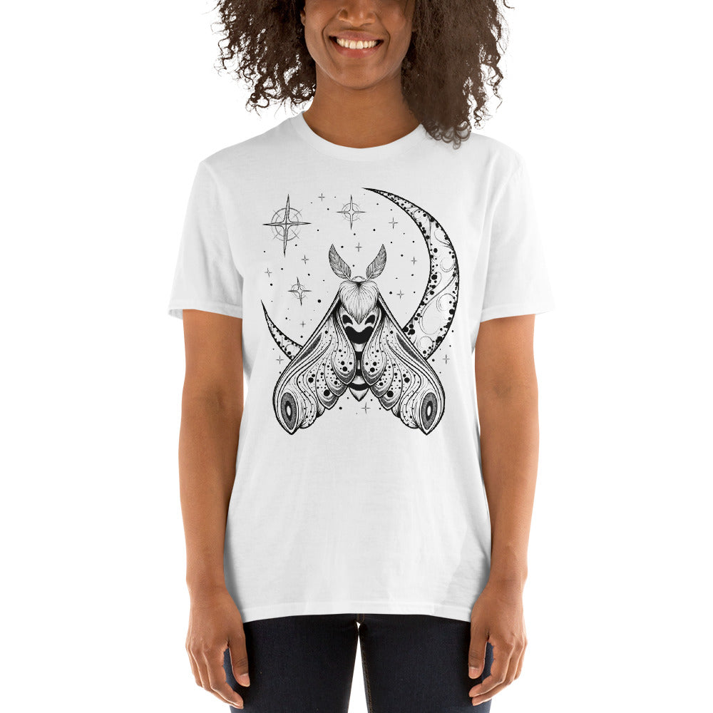 A woman wearing a white t-shirt with a black crescent moon and stars with an ornate moth in front of the bottom of the moon facing upward.