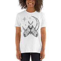 A woman wearing a white t-shirt with a black crescent moon and stars with an ornate moth in front of the bottom of the moon facing upward.