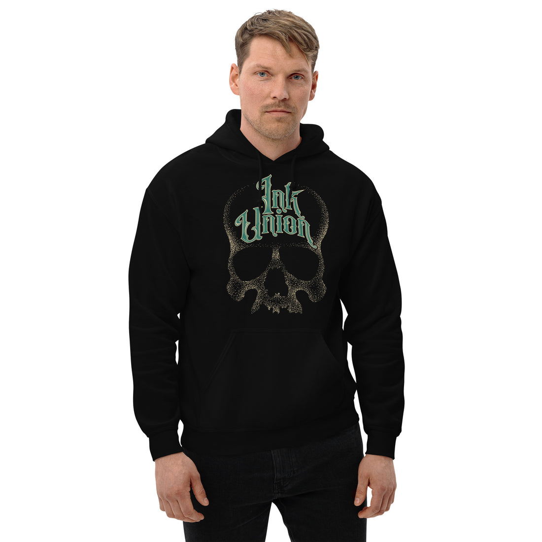 An attractive man wearing a black hoodie adorned with a gold dot work human skull and the words Ink Union in fancy gold and green lettering across the forehead of the skull.