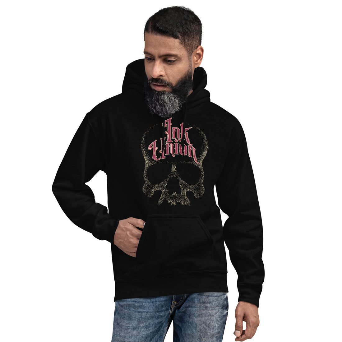 An attractive man wearing a black hoodie adorned with a gold dot work human skull and the words Ink Union in fancy gold and red lettering across the forehead of the skull.
