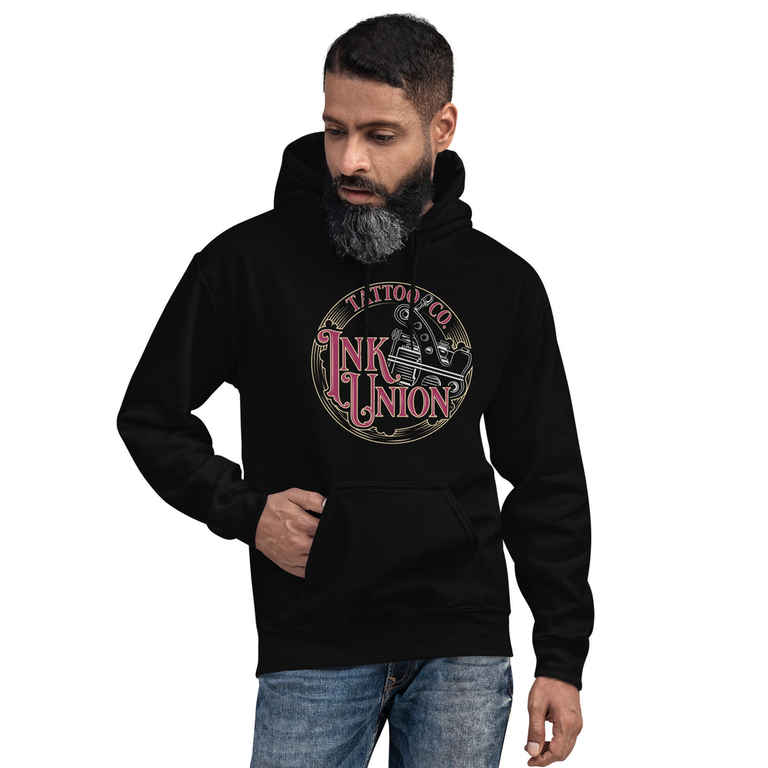 An attractive man wearing a black hoodie  adorned with the Ink Union Tattoo Co. red and gold with a silver tattoo machine logo.