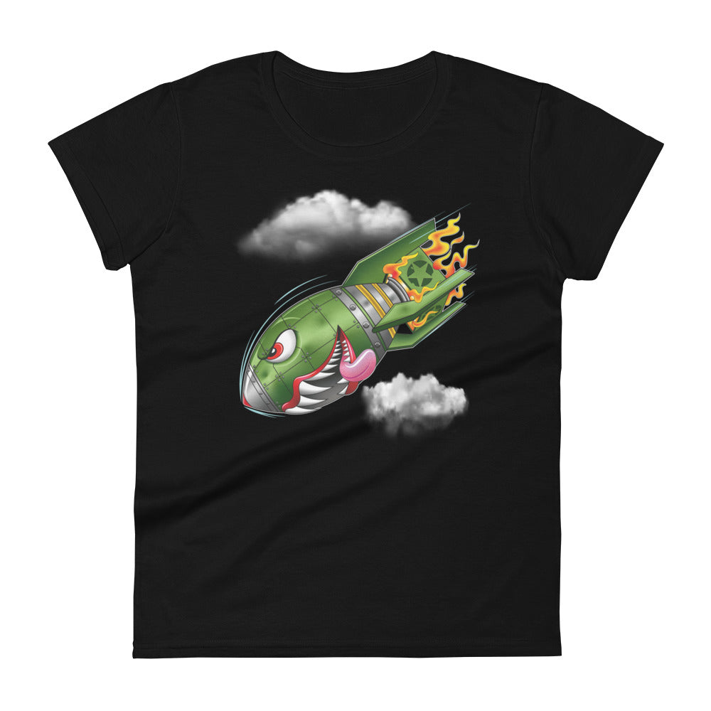 A black t-shirt with a military green neo-traditional bomb tattoo design. The bomb is falling with a look of determination in its eyes, an evil toothy grin, and its tongue hanging out of its mouth. Flames are coming from the back of the bomb, and some clouds are in the background.