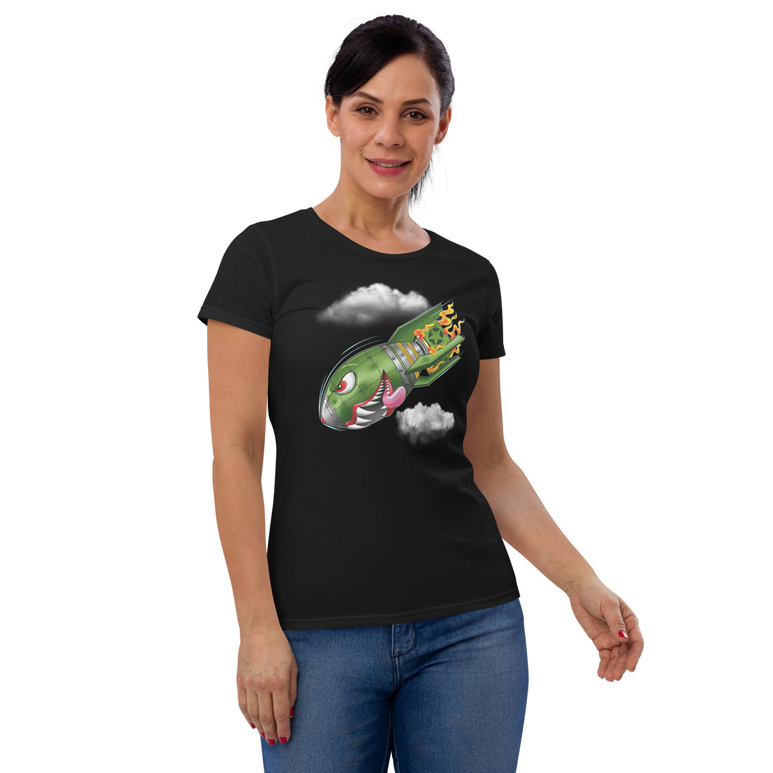 An attractive woman wears a black t-shirt with a military green neo-traditional bomb tattoo design. The bomb is falling with a look of determination in its eyes, an evil toothy grin, and its tongue hanging out of its mouth. Flames are coming from the back of the bomb, and some clouds are in the background.