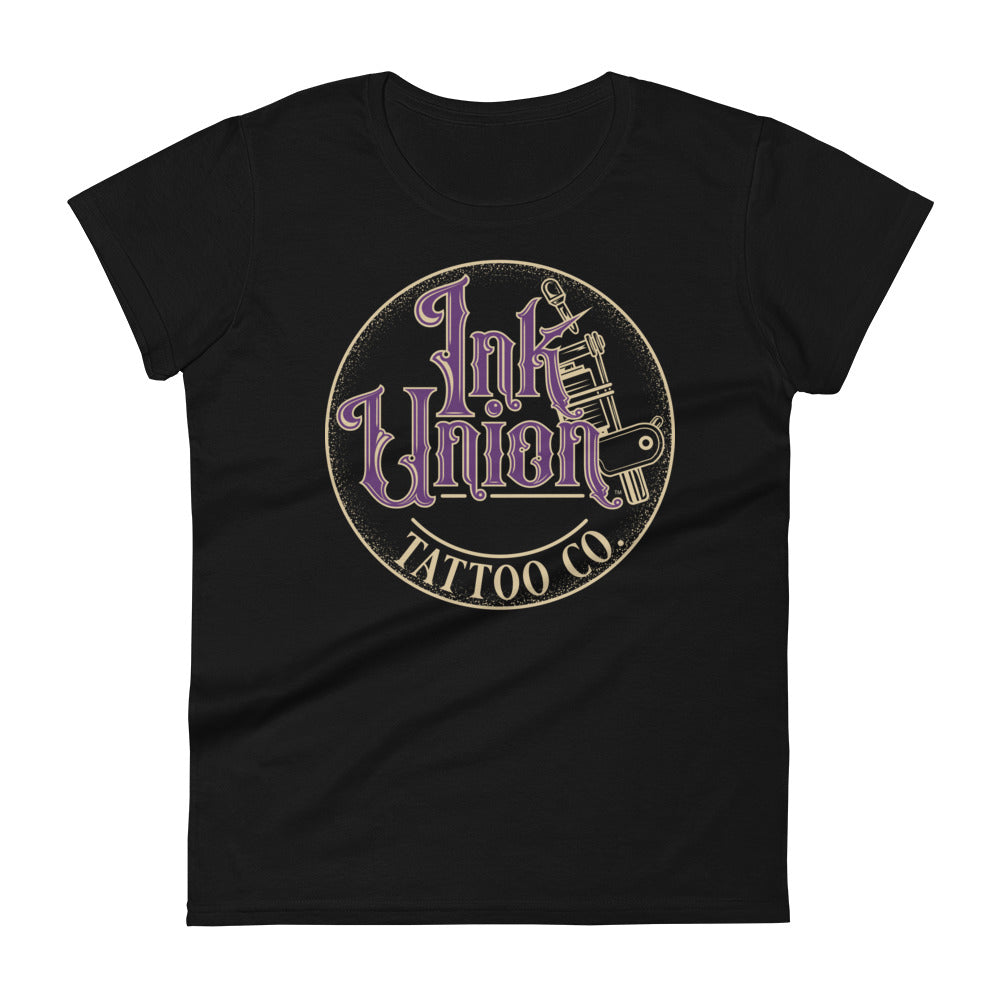 A black t-shirt with a gold circle containing fancy lettering in purple and gold that says Ink Union and a gold tattoo machine peeking out from behind on the right side.  There is a dot work gradient inside the circle, and the words Tattoo Co. in gold are at the bottom of the design.
