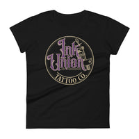 A black t-shirt with a gold circle containing fancy lettering in purple and gold that says Ink Union and a gold tattoo machine peeking out from behind on the right side.  There is a dot work gradient inside the circle, and the words Tattoo Co. in gold are at the bottom of the design.