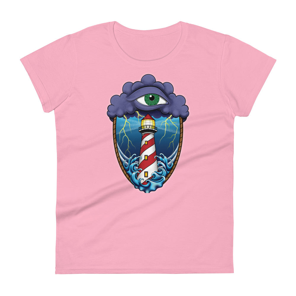 A pink t-shirt with an old school eye of the storm tattoo design of large dark purple storm clouds at the top of the design with a green eye in the middle of the clouds.  Below the clouds is an oval shape with brown rope. Inside the rope are stormy seas and a lighthouse with lightning striking in the background.  At the bottom of the design, some of the waves are spilling out of the rope barrier. The sky and seas are hues of blue; the lighthouse is white and red striped like a barber pole.