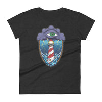 A dark grey t-shirt with an old school eye of the storm tattoo design of large dark purple storm clouds at the top of the design with a green eye in the middle of the clouds.  Below the clouds is an oval shape with brown rope. Inside the rope are stormy seas and a lighthouse with lightning striking in the background.  At the bottom of the design, some of the waves are spilling out of the rope barrier. The sky and seas are hues of blue; the lighthouse is white and red striped like a barber pole.