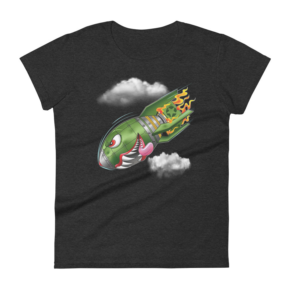 A dark grey t-shirt with a military green neo-traditional bomb tattoo design. The bomb is falling with a look of determination in its eyes, an evil toothy grin, and its tongue hanging out of its mouth. Flames are coming from the back of the bomb, and some clouds are in the background.