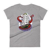 A light grey t-shirt with an old-school clipper ship tattoo design in green and brown with white sails surrounded by octopus tentacles in shades of red with purple tentacles. Behind the ship are purple-tinged clouds.