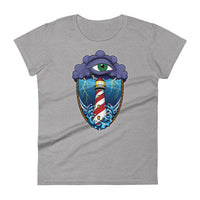 A light grey t-shirt with an old school eye of the storm tattoo design of large dark purple storm clouds at the top of the design with a green eye in the middle of the clouds.  Below the clouds is an oval shape with brown rope. Inside the rope are stormy seas and a lighthouse with lightning striking in the background.  At the bottom of the design, some of the waves are spilling out of the rope barrier. The sky and seas are hues of blue; the lighthouse is white and red striped like a barber pole.