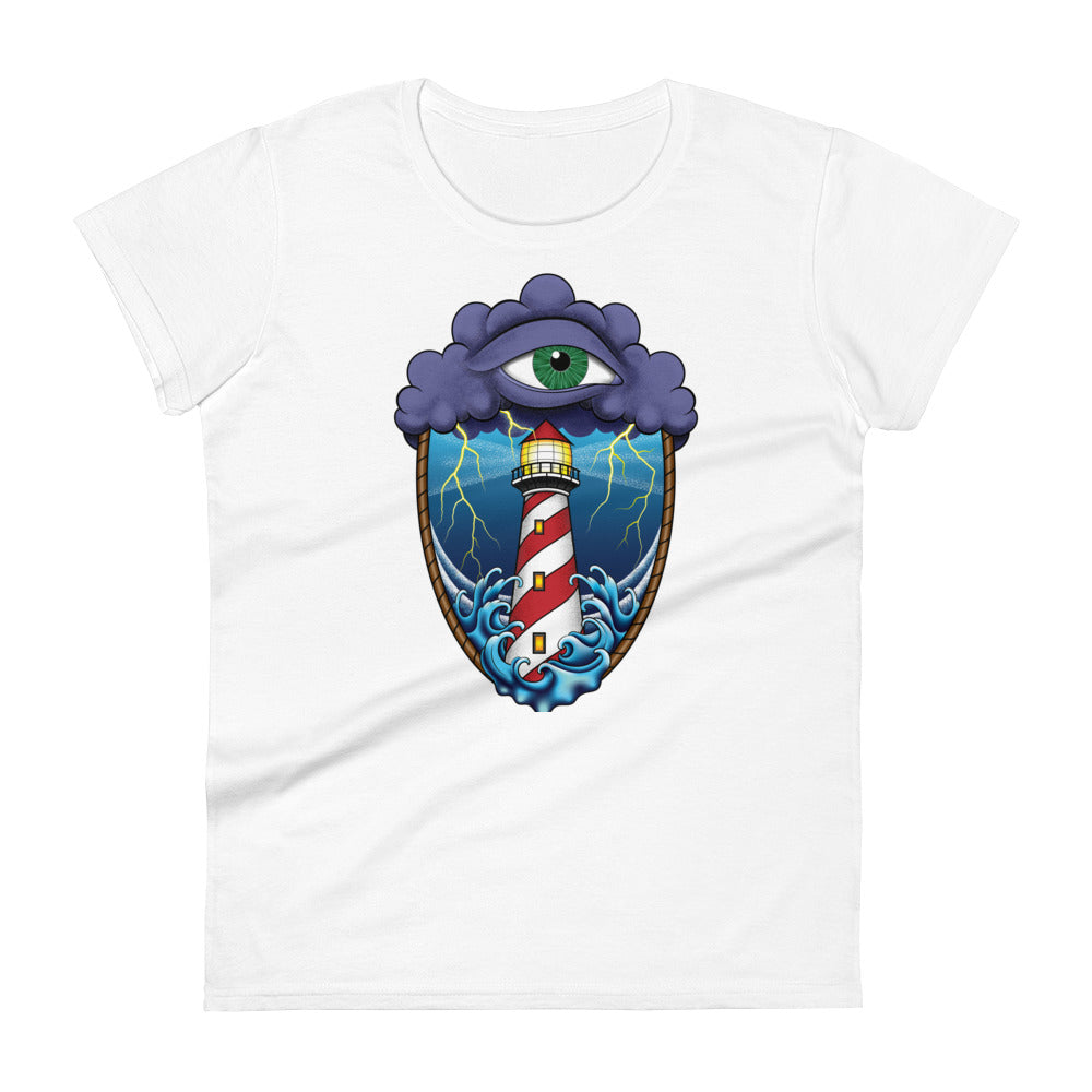 A white t-shirt with an old school eye of the storm tattoo design of large dark purple storm clouds at the top of the design with a green eye in the middle of the clouds.  Below the clouds is an oval shape with brown rope. Inside the rope are stormy seas and a lighthouse with lightning striking in the background.  At the bottom of the design, some of the waves are spilling out of the rope barrier. The sky and seas are hues of blue; the lighthouse is white and red striped like a barber pole.