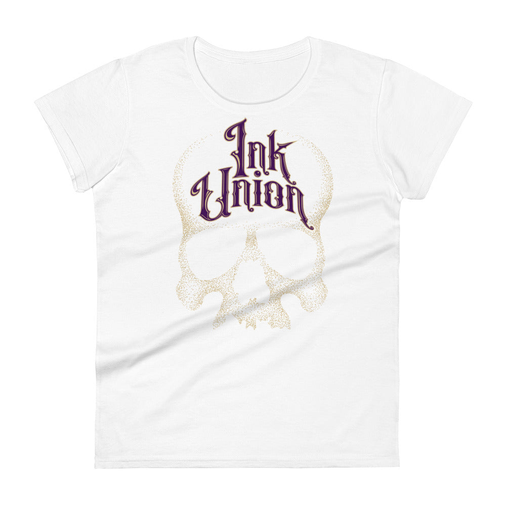 A white t-shirt adorned with a gold dot work human skull  and the words Ink Union in fancy gold and purple lettering across the forehead of the skull.