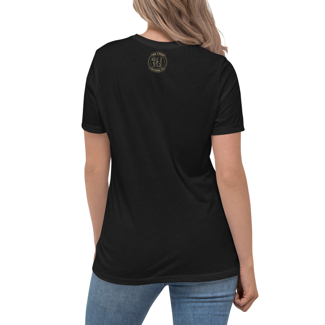 The rear view of an attractive woman wearing a black t-shirt with a small gold Ink Union Clothing Co. logo positioned just below the collar.