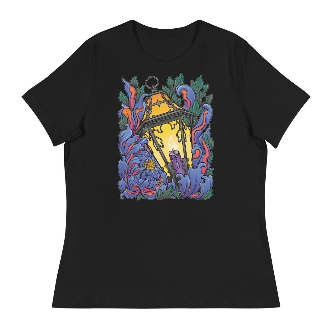 A black t-shirt with Chrysanthemum petals in blues and reds wrapped around an antique lantern lit by a candle. Dark green leaves border the image at the top and bottom behind the flower petals.