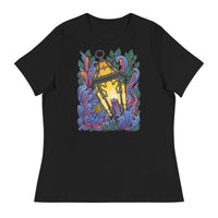 A black t-shirt with Chrysanthemum petals in blues and reds wrapped around an antique lantern lit by a candle. Dark green leaves border the image at the top and bottom behind the flower petals.