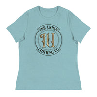 A heather blue t-shirt with the Ink Union Clothing Co Badge logo in black and gold centered on the front of the shirt.