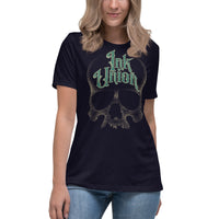 An attractive woman wearing a black t-shirt  adorned with a gold dot work human skull and the words Ink Union in fancy gold and green lettering across the forehead of the skull.