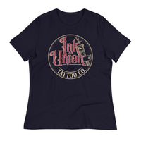 A navy blue t-shirt with a gold circle containing fancy lettering in red and gold that says Ink Union and a gold tattoo machine peeking out from behind on the right side.  There is a dot work gradient inside the circle, and the words Tattoo Co. in gold are at the bottom of the design.