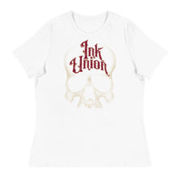 A white t-shirt adorned with a gold dot work human skull  and the words Ink Union in fancy gold and red lettering across the forehead of the skull.