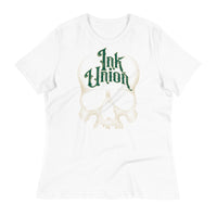 A white t-shirt adorned with a gold dot work human skull  and the words Ink Union in fancy gold and green lettering across the forehead of the skull.