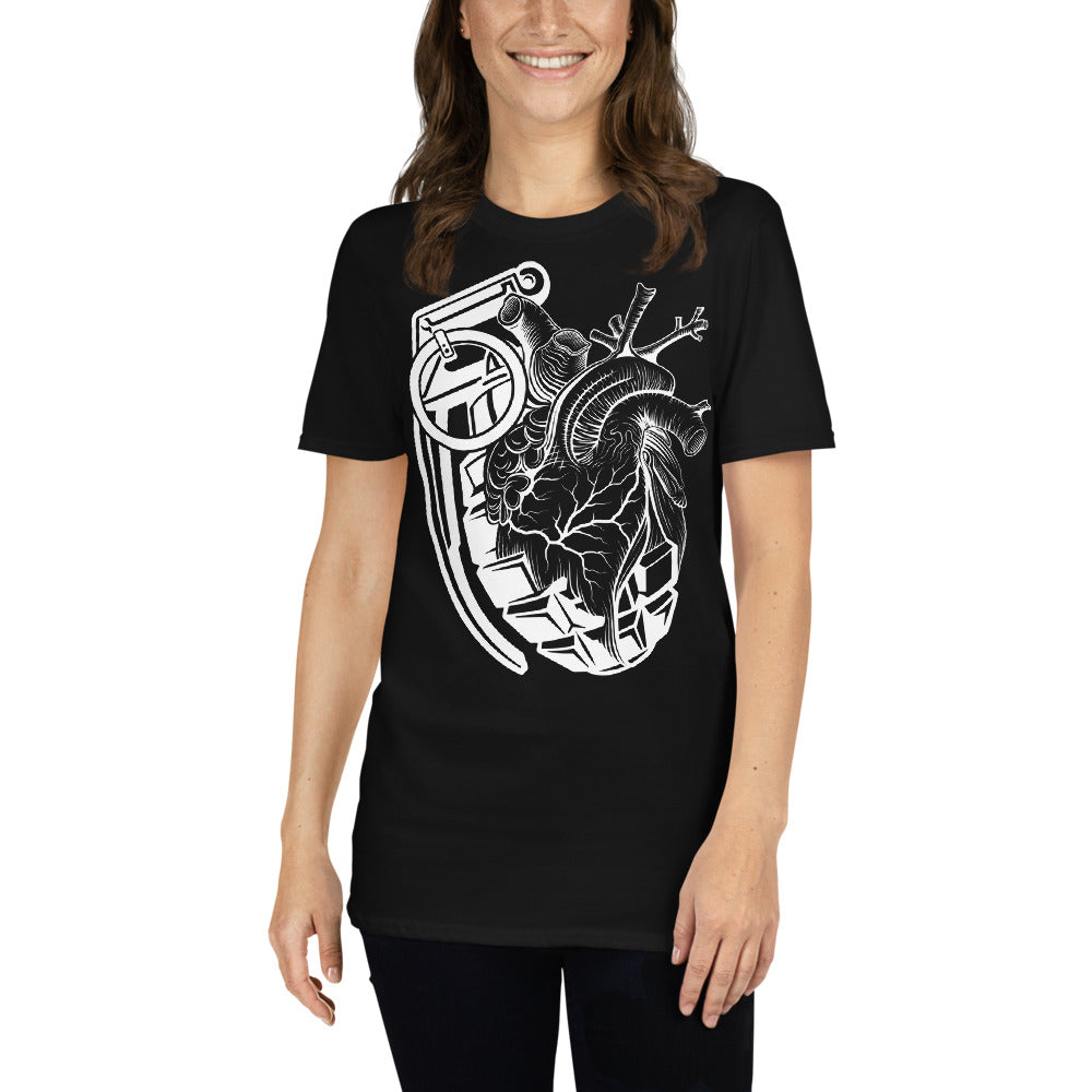 An attractive woman wearing a black t-shirt with a black grenade of sold color and line work morphing into an anatomical heart drawn using line work for shading at the top right of the image.