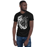 An attractive man wearing a black t-shirt with a black grenade of sold color and line work morphing into an anatomical heart drawn using line work for shading at the top right of the image.